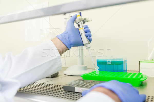 Scientist in laboratory filling liquid in appliance Stock photo © Kzenon