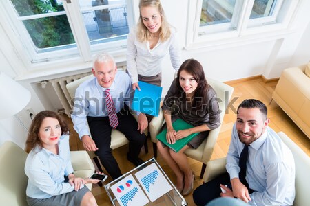 Young cheerful people showing thumbs up for co-working Stock photo © Kzenon