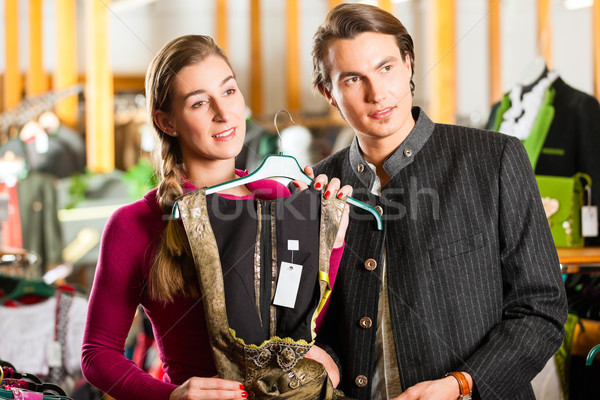Young couple is buying Tracht or dirndl in a shop Stock photo © Kzenon