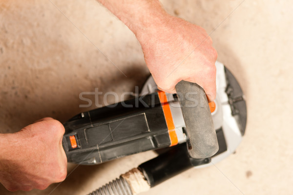 Cemento piso trabajador de la construcción de trabajo mano máquina Foto stock © Kzenon
