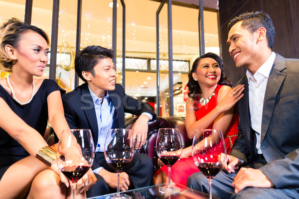 Asian Friends drinking wine in bar Stock photo © Kzenon