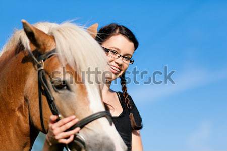 Woman petting horse on pony farm Stock photo © Kzenon