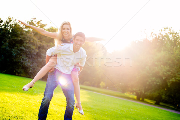 Homem menina piggyback verão pôr do sol Foto stock © Kzenon