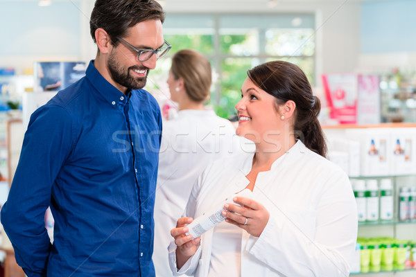 Pharmacist or drug store sales woman advising customer Stock photo © Kzenon