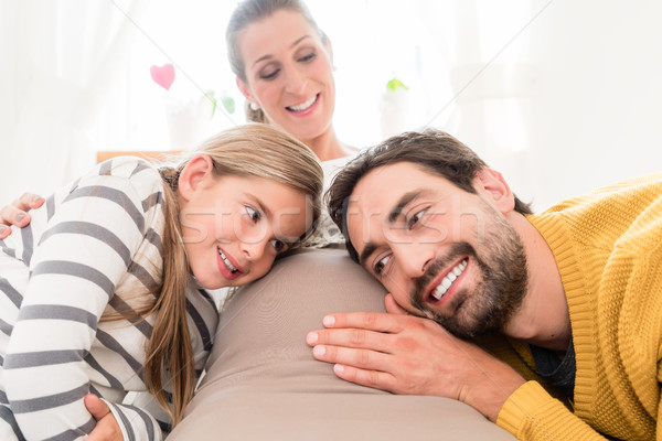 Girl and dad listening for motions of soon-to-be sibling Stock photo © Kzenon