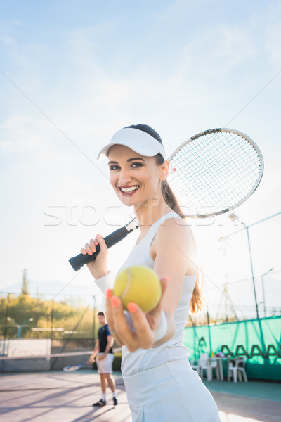 Stock photo: Woman going about playing Tennis