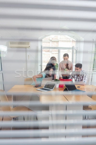 Stock photo: young independent workers sharing the facilities of a modern co-working space