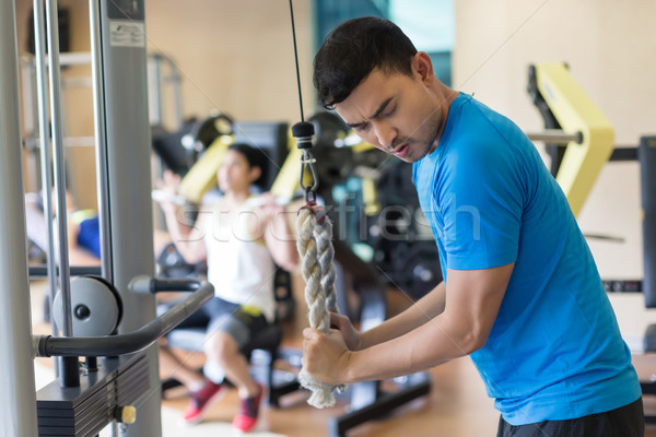 Fiatalember testmozgás tricepsz intenzív edzés tornaterem Stock fotó © Kzenon