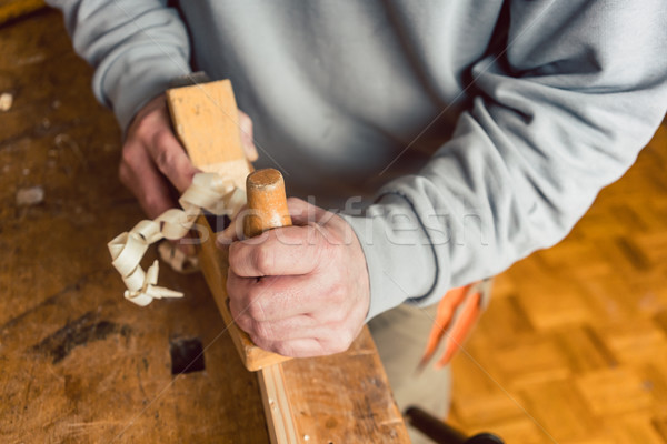 Hand of a senior carpenter with wood planer Stock photo © Kzenon