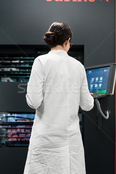 pharmacist using a computer while managing the drug stock in pharmacy Stock photo © Kzenon