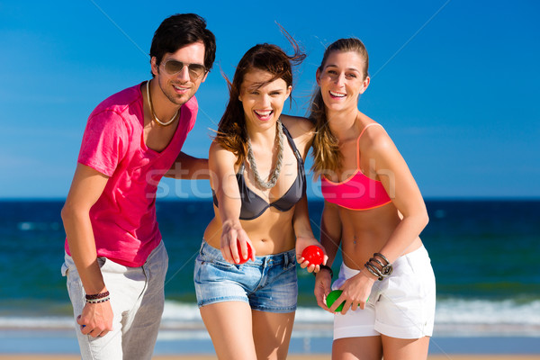 Man and women playing boule on beach Stock photo © Kzenon