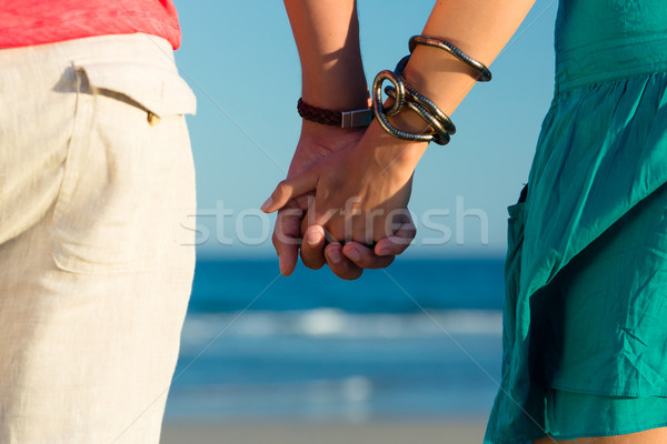 Man and woman enjoying sunset on beach Stock photo © Kzenon
