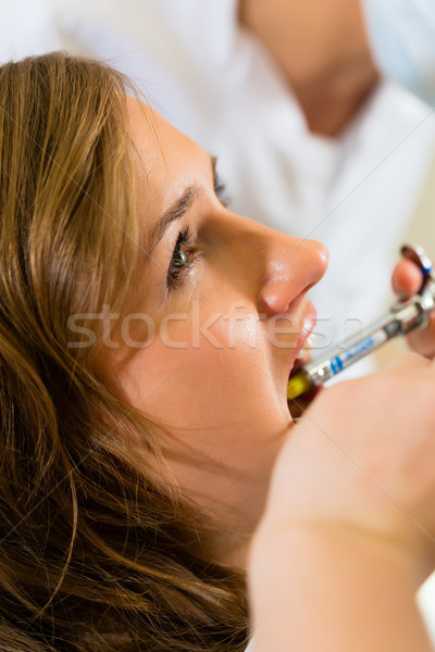 Syringe - dentist gives anesthesia Stock photo © Kzenon