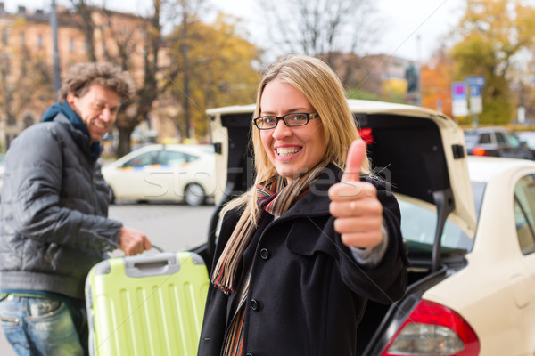 Young woman in front of taxi Stock photo © Kzenon