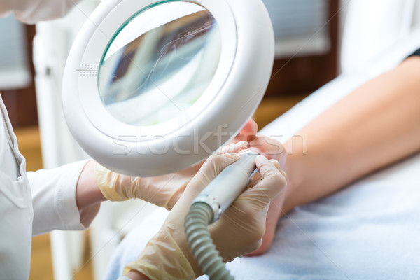 Woman receiving podiatry treatment in Day Spa Stock photo © Kzenon