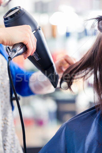 Hairdresser blow dry woman hair in shop Stock photo © Kzenon