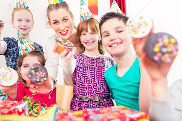 Kids showing muffin cakes at birthday party Stock photo © Kzenon