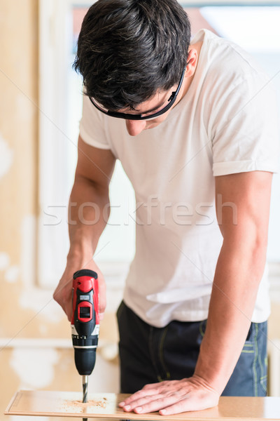 Craftsman or DIY man working with power drill Stock photo © Kzenon