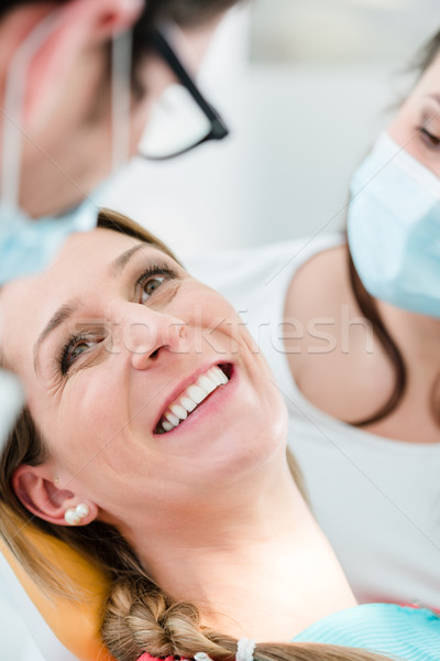 Woman with healthy smile at dentist  Stock photo © Kzenon