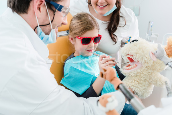 Child at dentist office looking after teeth of pet toy Stock photo © Kzenon