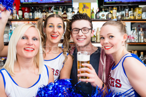 Fans of a sports team watching game in bar Stock photo © Kzenon