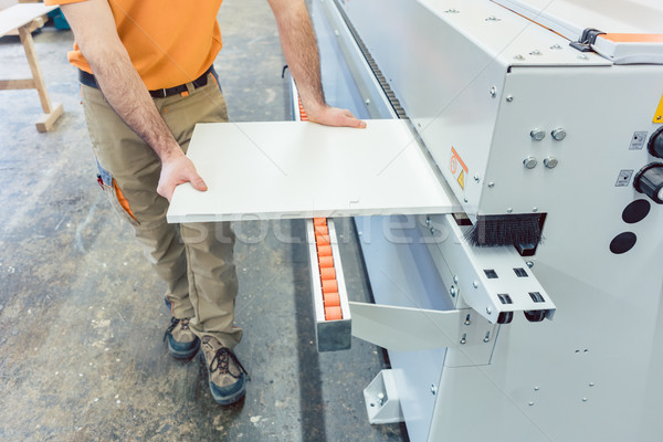 Carpenter in furniture factory working on veneer machine Stock photo © Kzenon