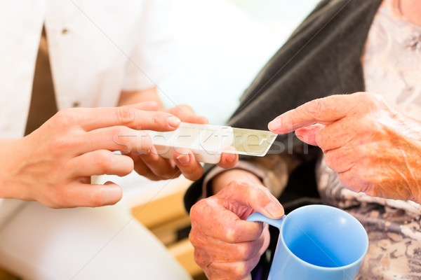 Young nurse and female senior in nursing home Stock photo © Kzenon