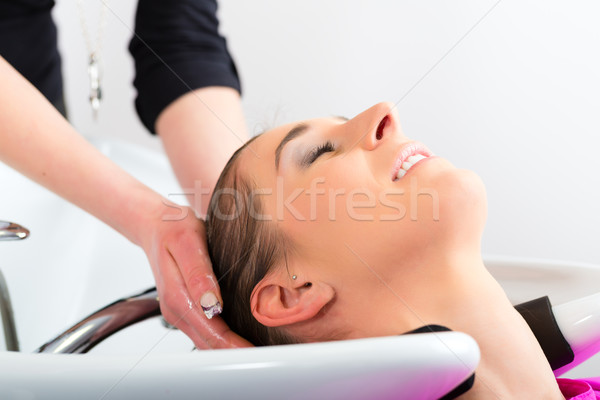 Woman at the hairdresser washing hair Stock photo © Kzenon