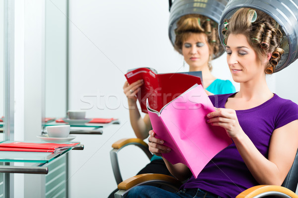 Women at the hairdresser with hair dryer Stock photo © Kzenon