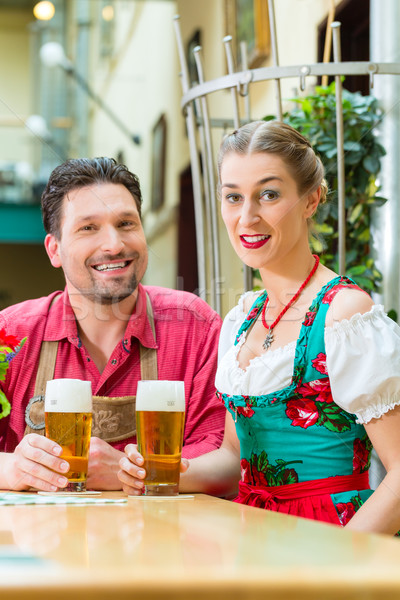 Young couple in Bavaria in restaurant or pub Stock photo © Kzenon
