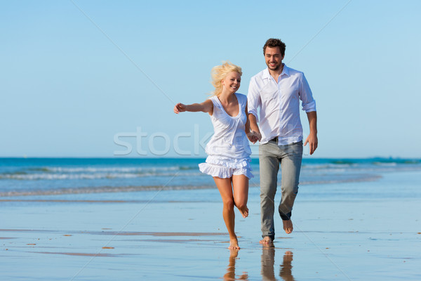 Couple on the beach running into glorious future Stock photo © Kzenon