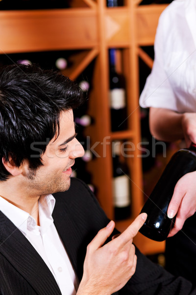 Waitress offers a bottle of red wine  Stock photo © Kzenon