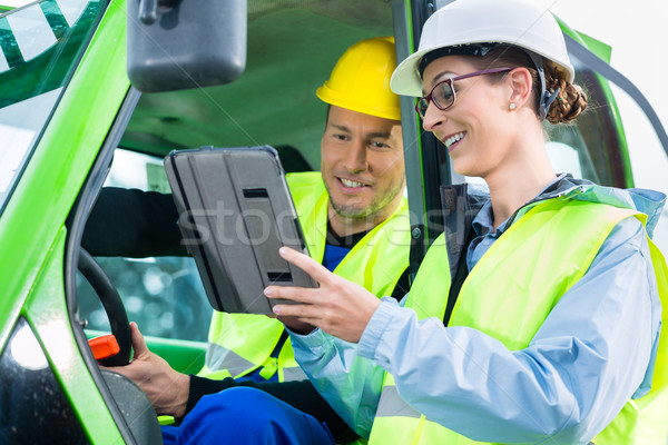 Construction worker discussing with engineer blueprints  Stock photo © Kzenon