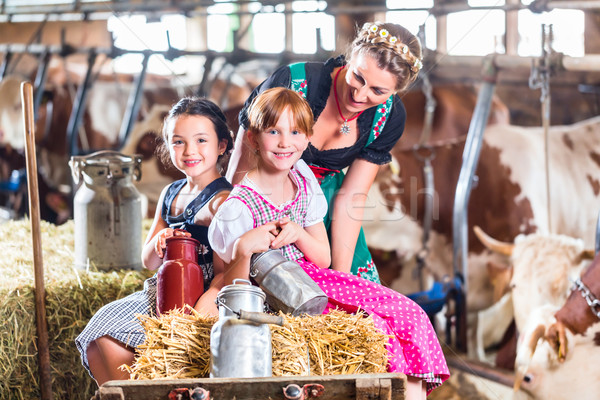 Bavaria family driving pushcard in cow barn Stock photo © Kzenon