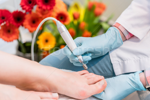 Close-up of the hands of a pedicurist wearing surgical gloves wh Stock photo © Kzenon