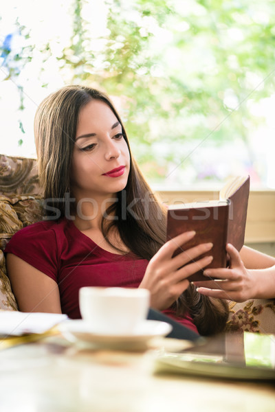 Relaxed attractive young woman enjoying a book Stock photo © Kzenon