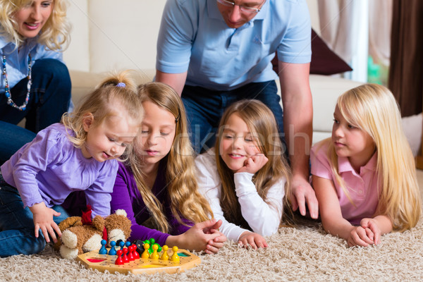 Family playing board game at home Stock photo © Kzenon