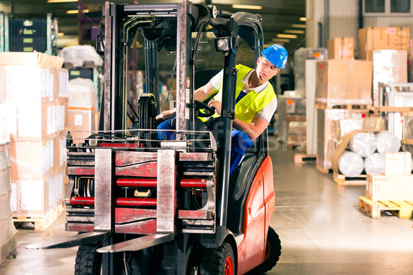 Stock photo: forklift driver at warehouse of forwarding