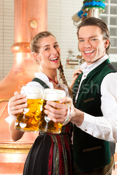 Man and woman with beer glass in brewery Stock photo © Kzenon
