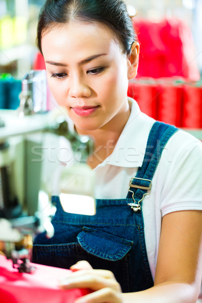 Seamstress in a chinese textile factory Stock photo © Kzenon
