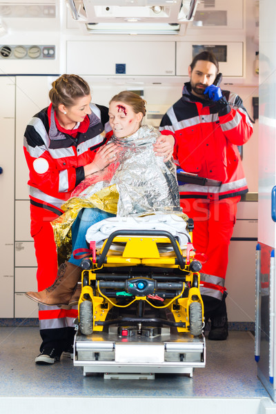 Ambulance helping injured woman Stock photo © Kzenon