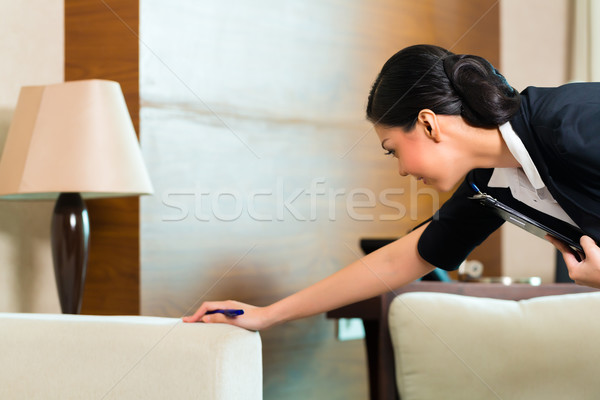 Asian Chinese housekeeper controlling hotel room Stock photo © Kzenon
