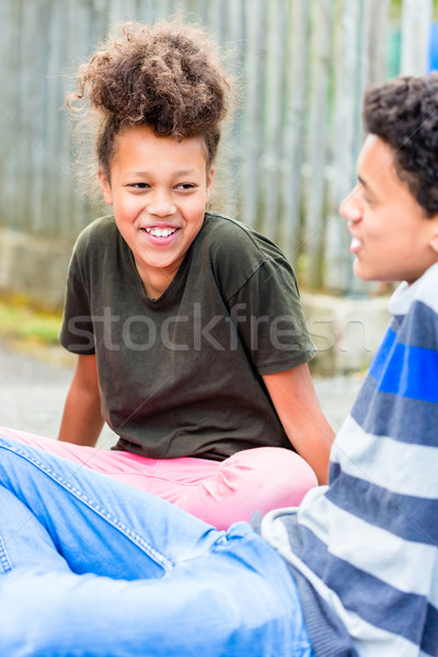 Siblings sitting on floor in yard Stock photo © Kzenon