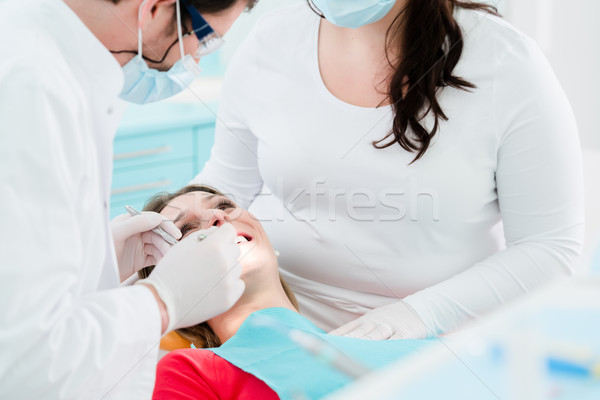 Patient treated by dentist in his surgery Stock photo © Kzenon