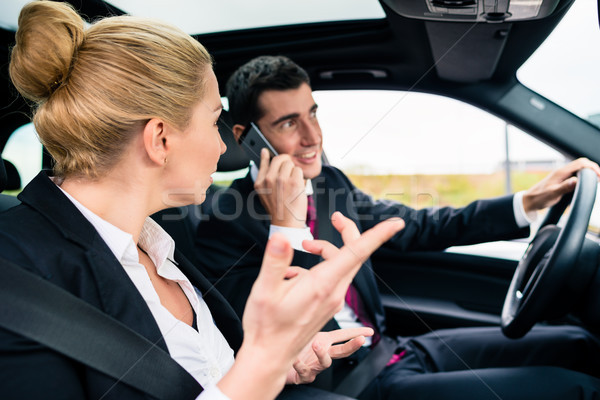 Stock photo: Woman in car being angry at phoning man