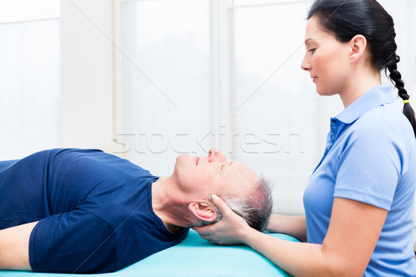 Senior man visiting physiotherapist for massage Stock photo © Kzenon