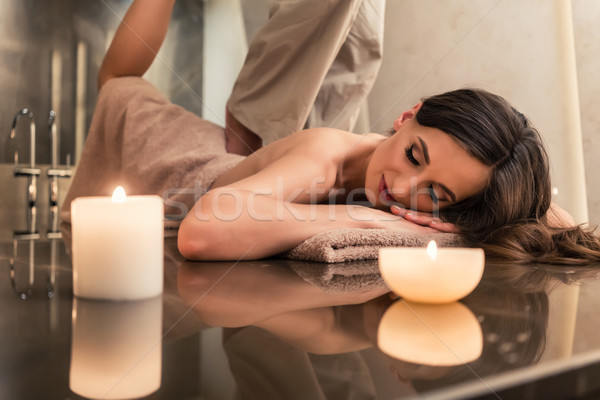 Young woman enjoying the stretching techniques of Thai massage Stock photo © Kzenon