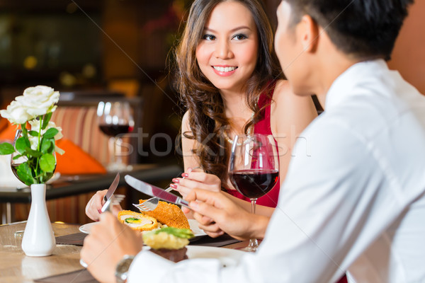 Chinese couple having romantic dinner in fancy restaurant Stock photo © Kzenon