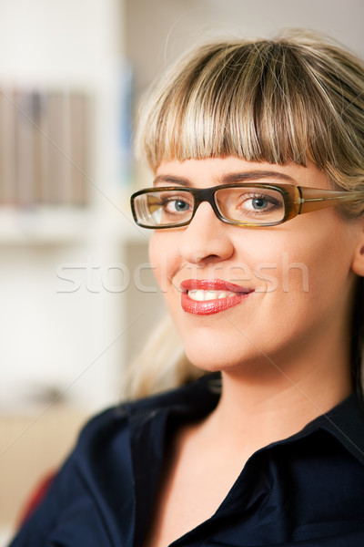 Stock photo: Woman in front of book shelf