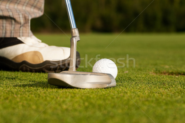 Putting golf ball in cup Stock photo © Kzenon